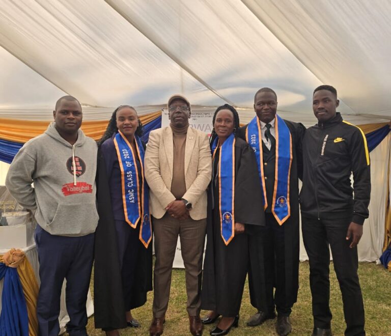 FIVE GRADUANDS AT THE ADVANCED SPORTS MANAGEMENT COURSE GRADUATION CEREMONY.